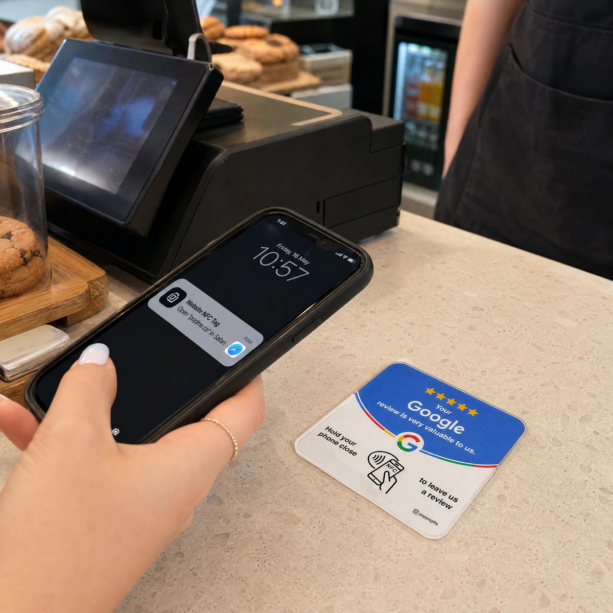 Phone reading a Google Review NFC card on a cafe counter