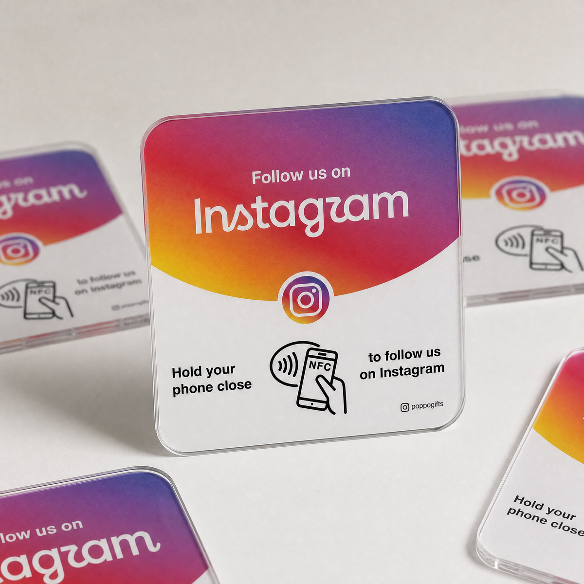 Instagram NFC card with pink-to-orange gradient design, shown with other cards