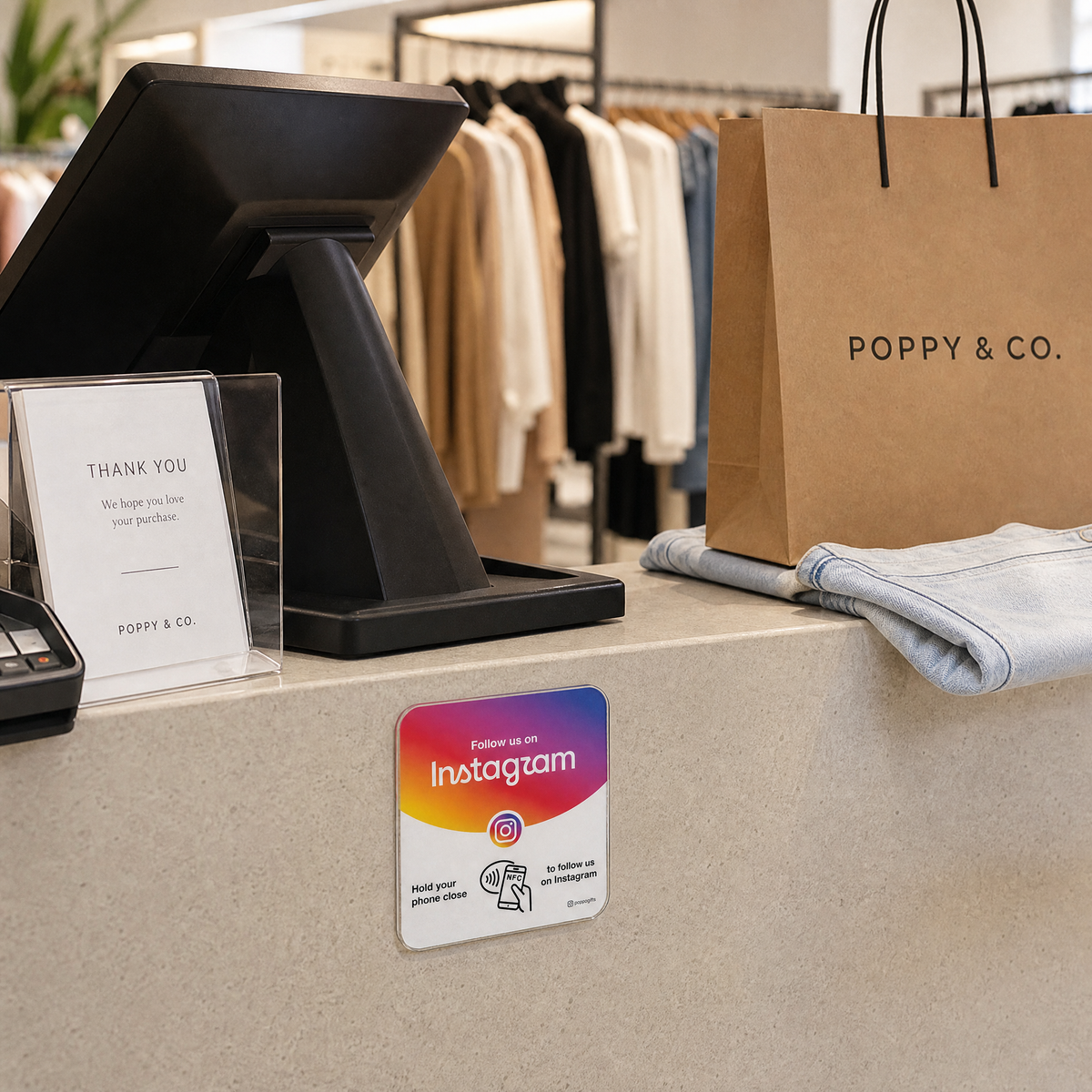 Instagram NFC card displayed on a clothing store checkout counter